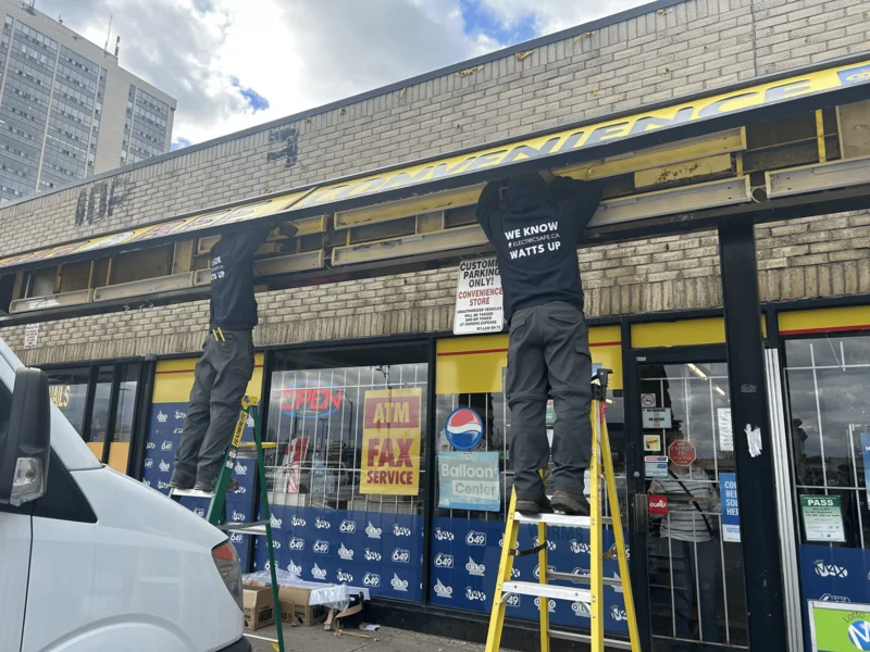 ElectricSafe electricians installing a new outdoor sign at Big Bee Convenience in Hamilton, ensuring safe and code-compliant electrical work for local businesses.