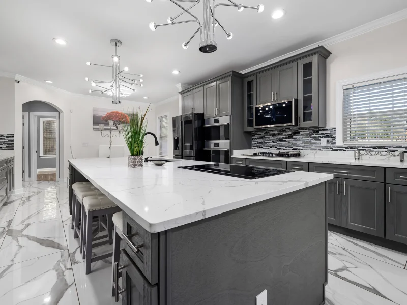 A luxurious kitchen in Grimsby with modern chandeliers, recessed lighting, and energy-efficient electrical work done by our Grimsby electricians.
