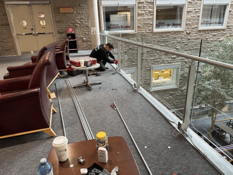 Licensed electricians from ElectricSafe installing electrical outlets at McMaster University, upgrading campus infrastructure for student convenience and safety.