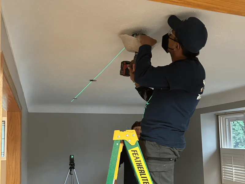 A Dundas electrician repairing unsafe electrical wiring in a residential home. The panel shows exposed wires and outdated components, requiring professional upgrades for safety and compliance.