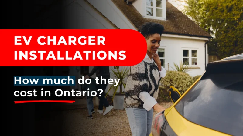 A homeowner, considering the cost to install an EV chargers, while she is charging an electric car.